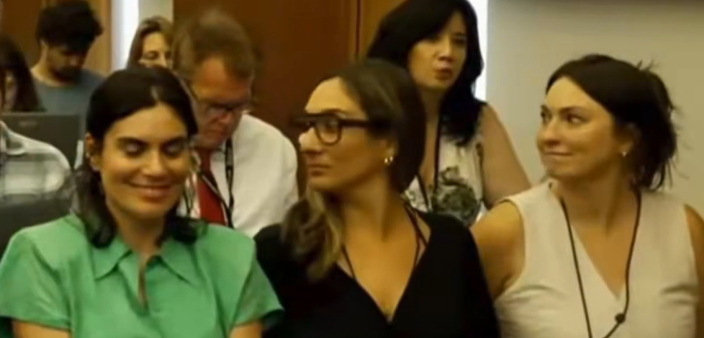Who Is The Smiling Woman In The Green Dress?!