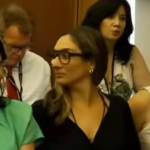 Who Is The Smiling Woman In The Green Dress?!
